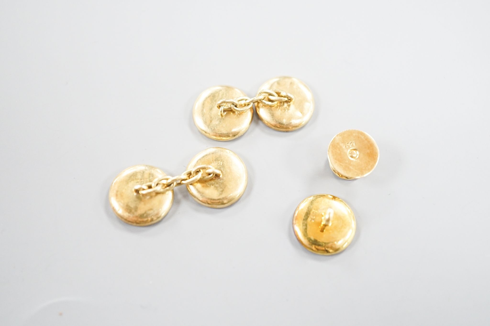 A pair of 18ct, mother of pearl and sapphire set circular cufflinks, 13mm and a pair of matching dress studs, gross weight 8.6 grams.